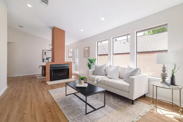 a living room with furniture and a fireplace