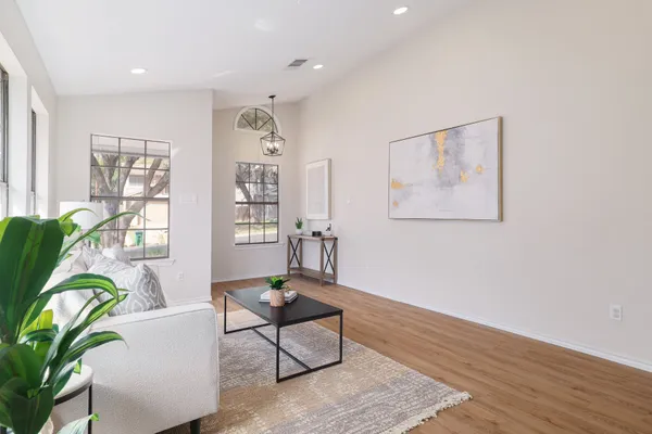 a living room with furniture and wooden floor
