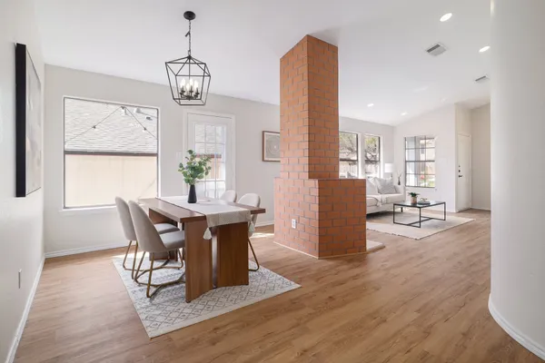 a view of a dining room with furniture window and wooden floor