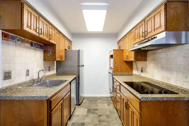 a bathroom with a sink toilet vanity and shower