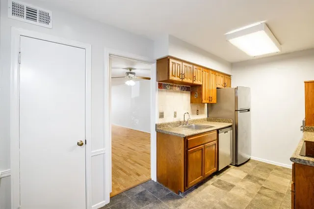 a view of a big room with windows and plants