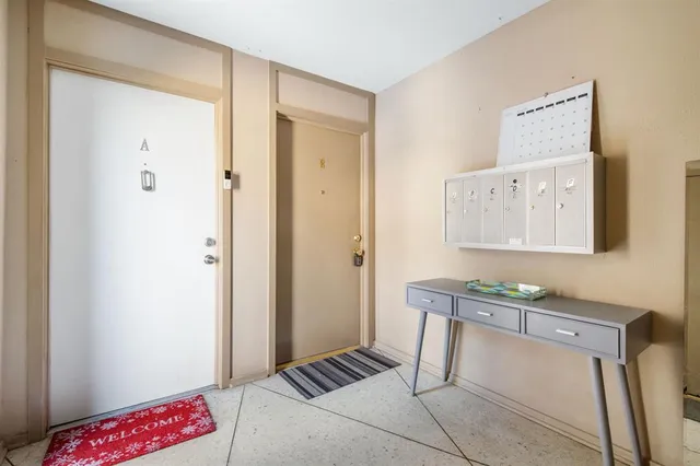 a view of a dining room with furniture and a chandelier