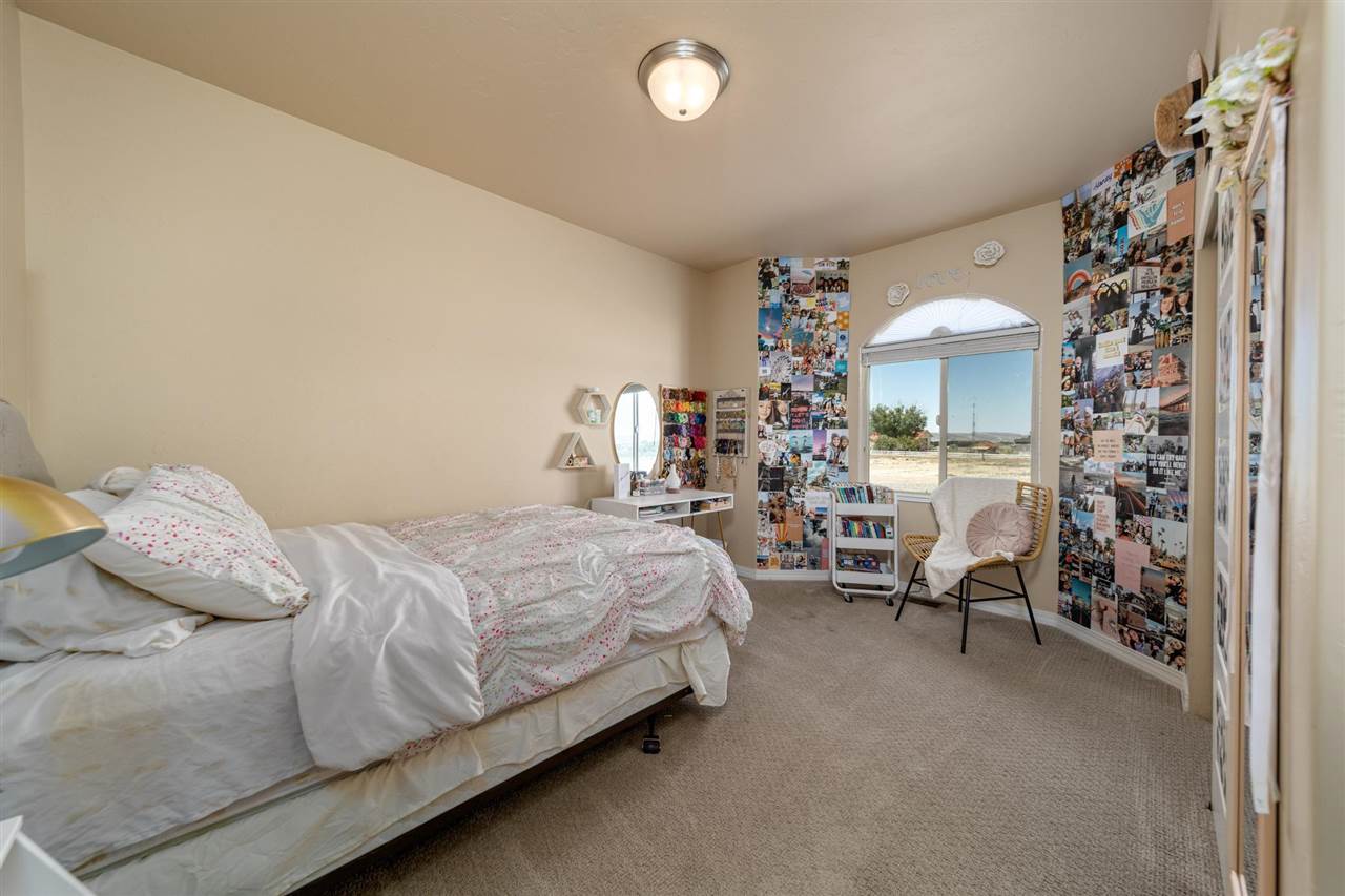 1554 17 Road Loma, CO 81524 - Photo 11 of 16 a bedroom with a bed and a chandelier