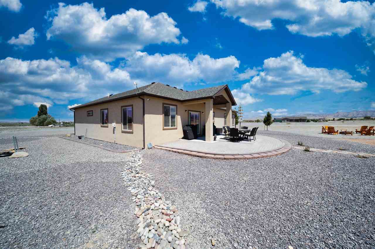 1554 17 Road Loma, CO 81524 - Photo 14 of 16 a view of a house with backyard and a tree