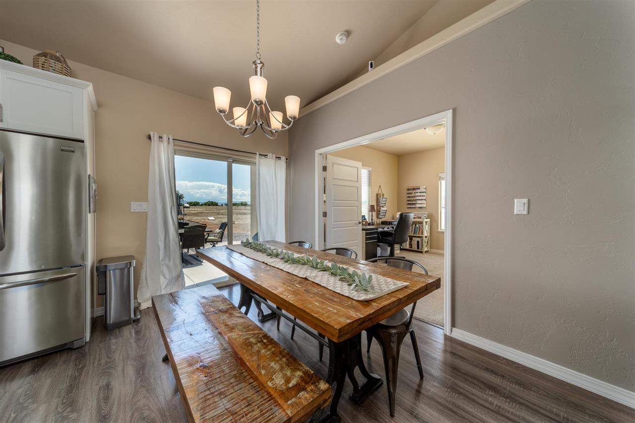 1554 17 Road Loma, CO 81524 - Photo 5 of 16 a view of a dining room with furniture a chandelier and wooden floor