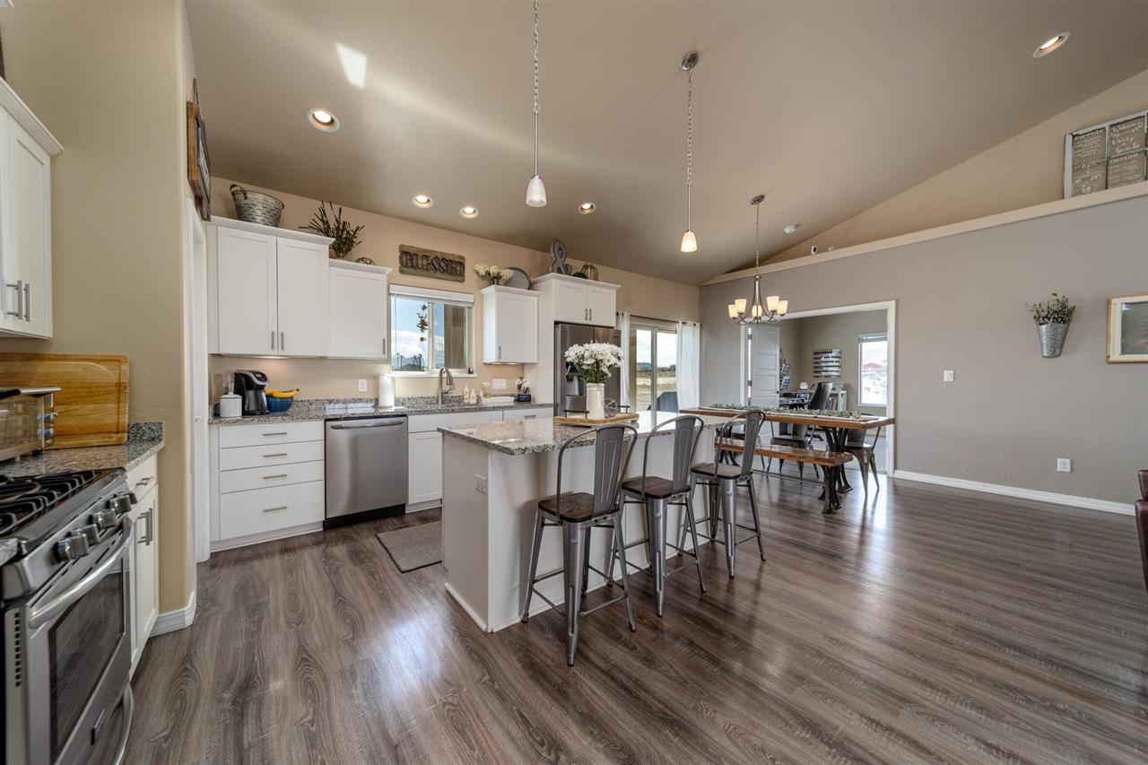 1554 17 Road Loma, CO 81524 - Photo 7 of 16 a kitchen with a table chairs refrigerator and cabinets
