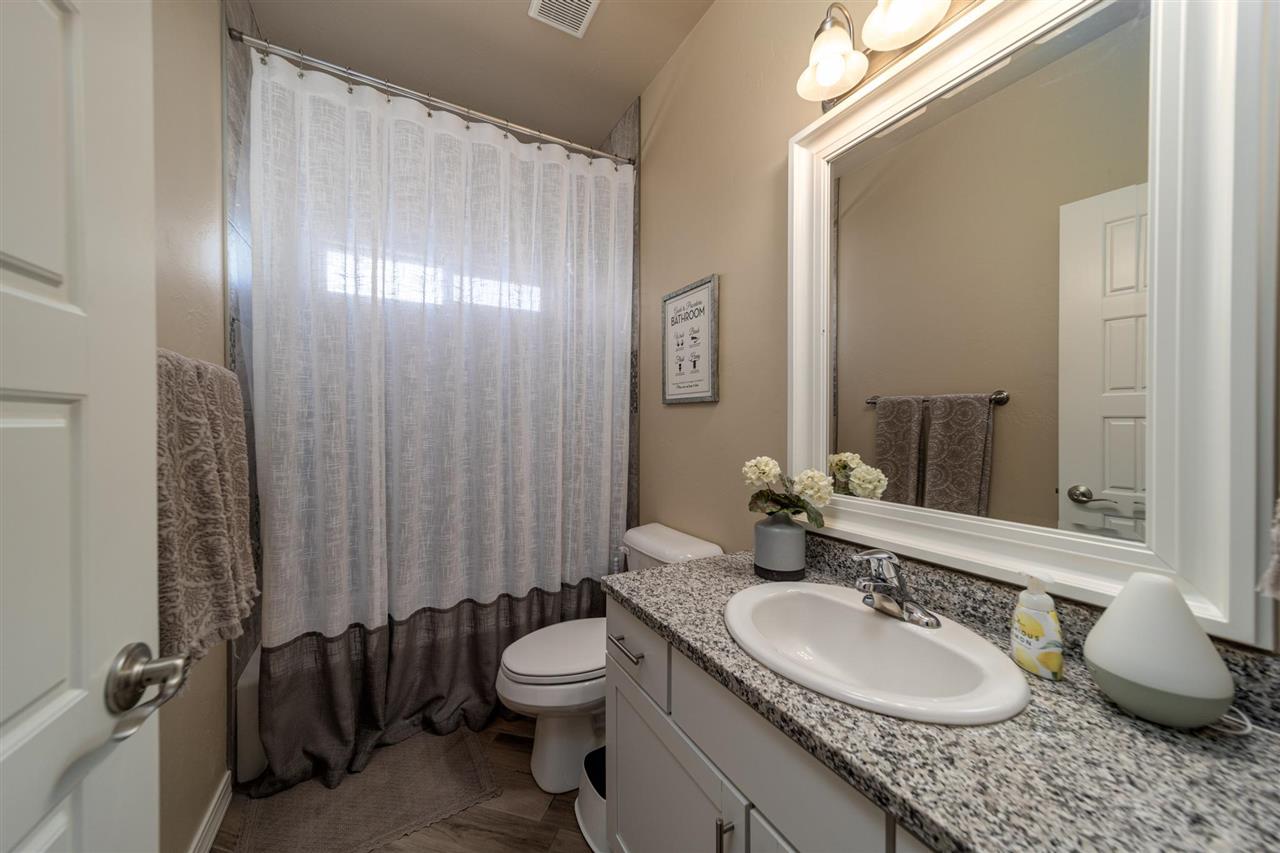1554 17 Road Loma, CO 81524 - Photo 10 of 16 a bathroom with a granite countertop sink toilet and a mirror