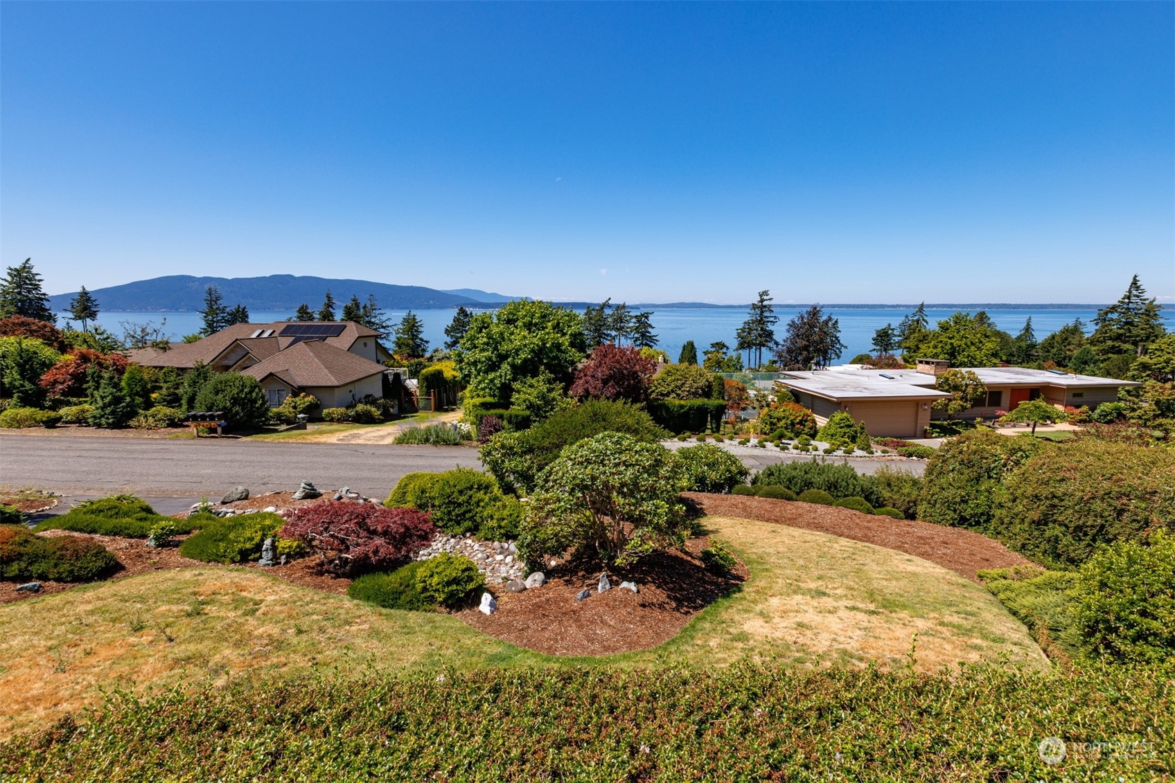 623 Briar Road Bellingham, WA 98225 - Photo 5 of 40 a view of a garden with a building in the background