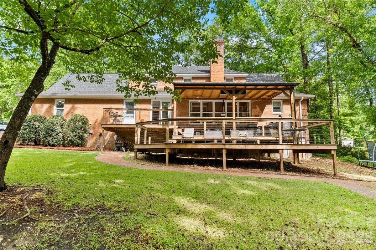209 Fairway Road Cheraw, SC 29520 - Photo 32 of 48 a view of a house with backyard sitting area and garden