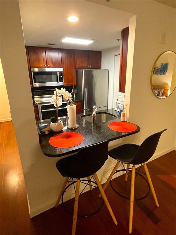 10 Museum Way, Unit 321 Cambridge, MA 02141 - Photo 8 of 15 a dinning room with furniture and wooden floor