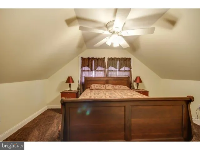 a bedroom with a bed and a mirror