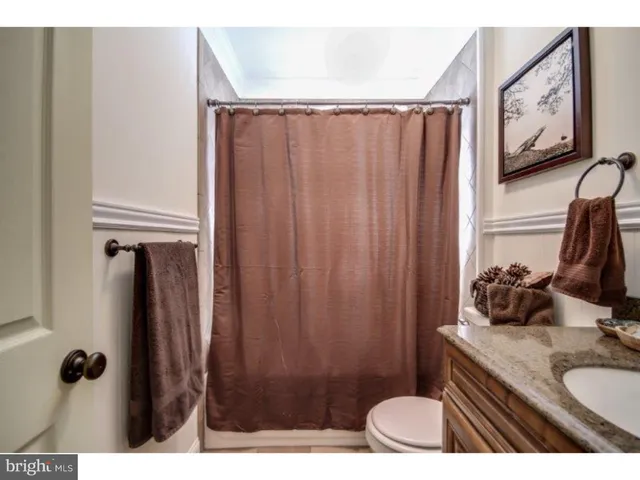 a bathroom with a sink vanity mirror and tub