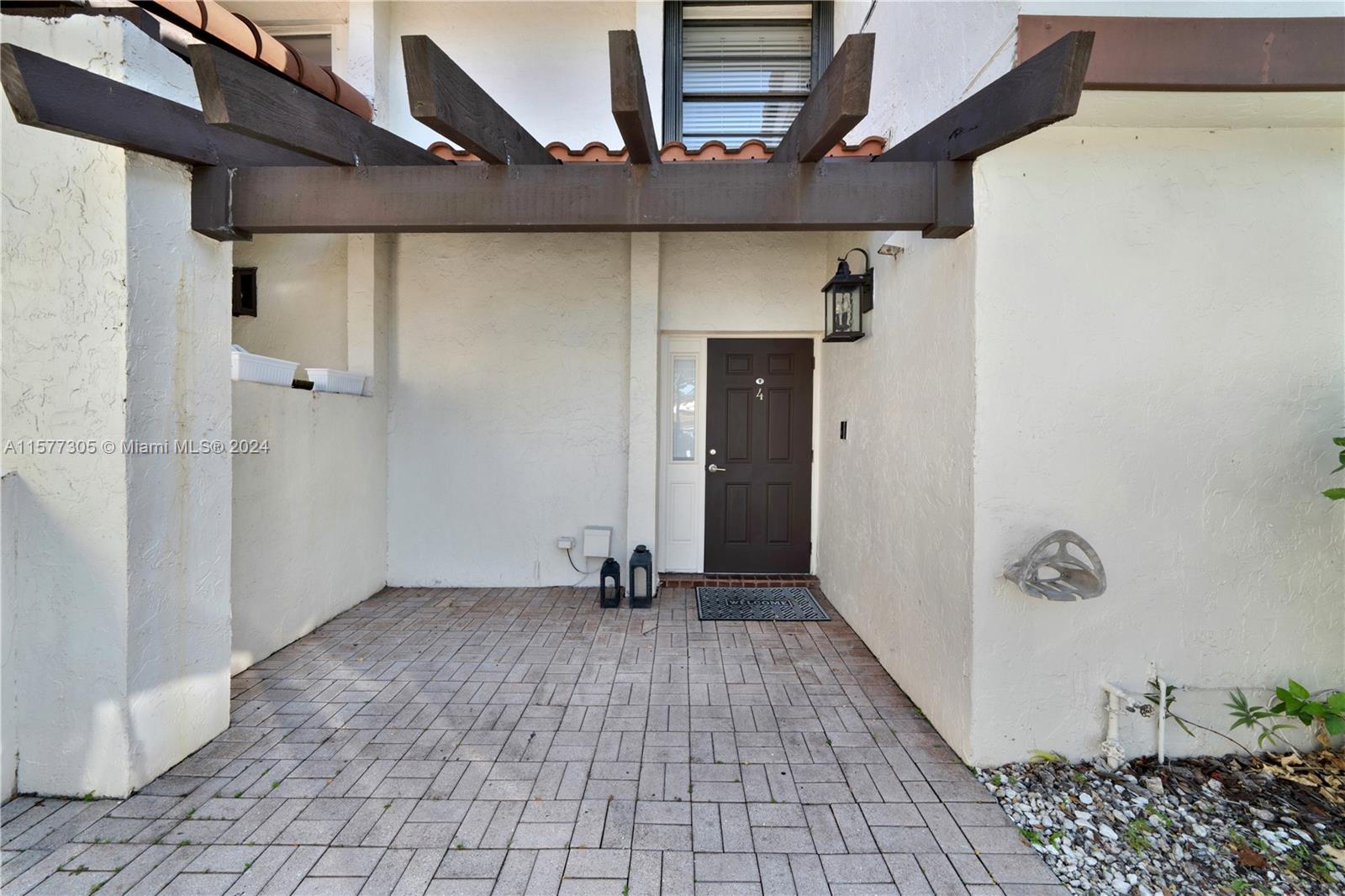 13339 Southwest 112th Terrace, Unit 504 Miami, FL 33186 - Photo 1 of 26 a view of a hallway with wooden walls and table