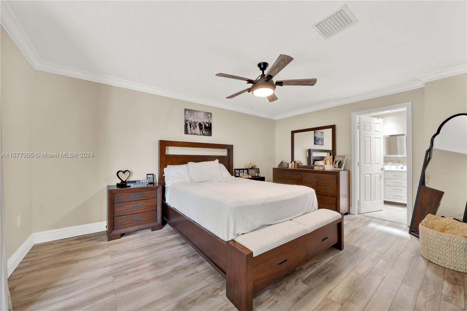 13339 Southwest 112th Terrace, Unit 504 Miami, FL 33186 - Photo 13 of 26 a bedroom with a bed and wooden floor
