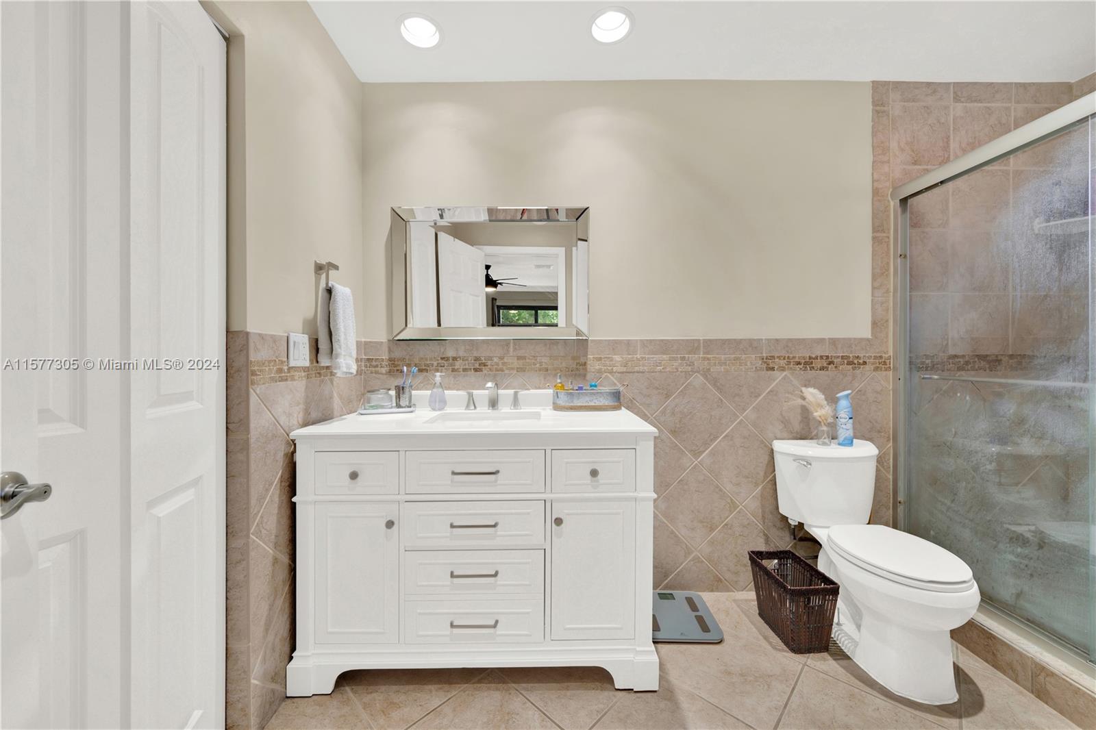13339 Southwest 112th Terrace, Unit 504 Miami, FL 33186 - Photo 15 of 26 a bathroom with a toilet sink and mirror