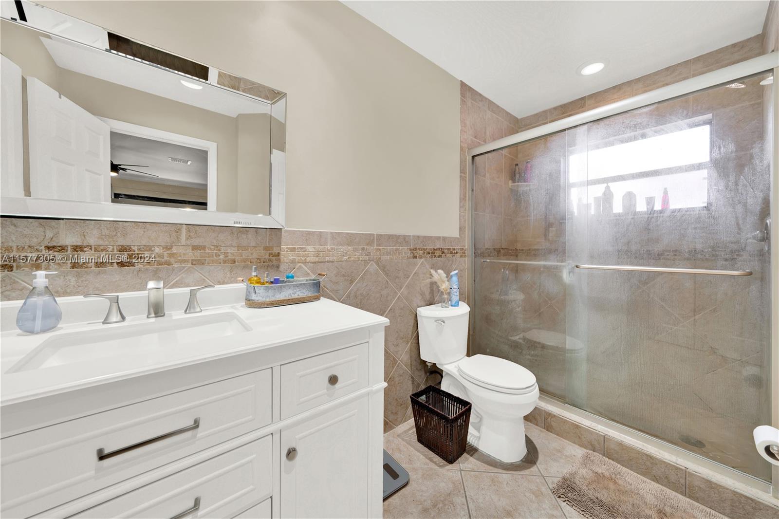 13339 Southwest 112th Terrace, Unit 504 Miami, FL 33186 - Photo 16 of 26 a bathroom with a sink a toilet and shower