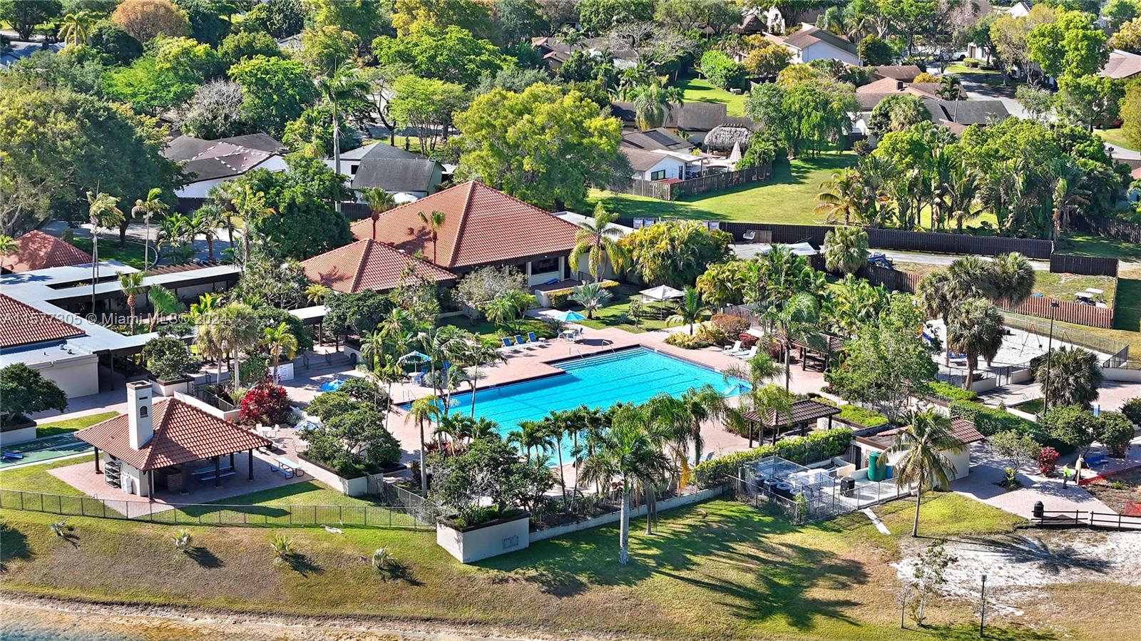 13339 Southwest 112th Terrace, Unit 504 Miami, FL 33186 - Photo 22 of 26 a view of a house with a yard and sitting area