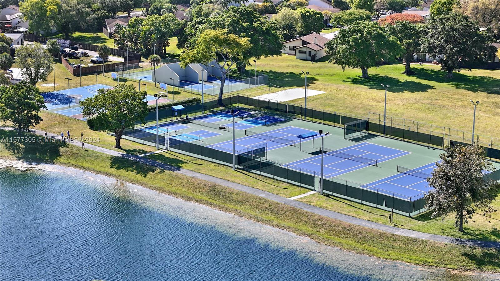 13339 Southwest 112th Terrace, Unit 504 Miami, FL 33186 - Photo 23 of 26 an aerial view of a houses with yard