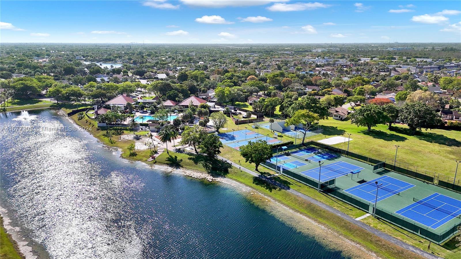 13339 Southwest 112th Terrace, Unit 504 Miami, FL 33186 - Photo 24 of 26 an aerial view of residential houses with outdoor space and lake view