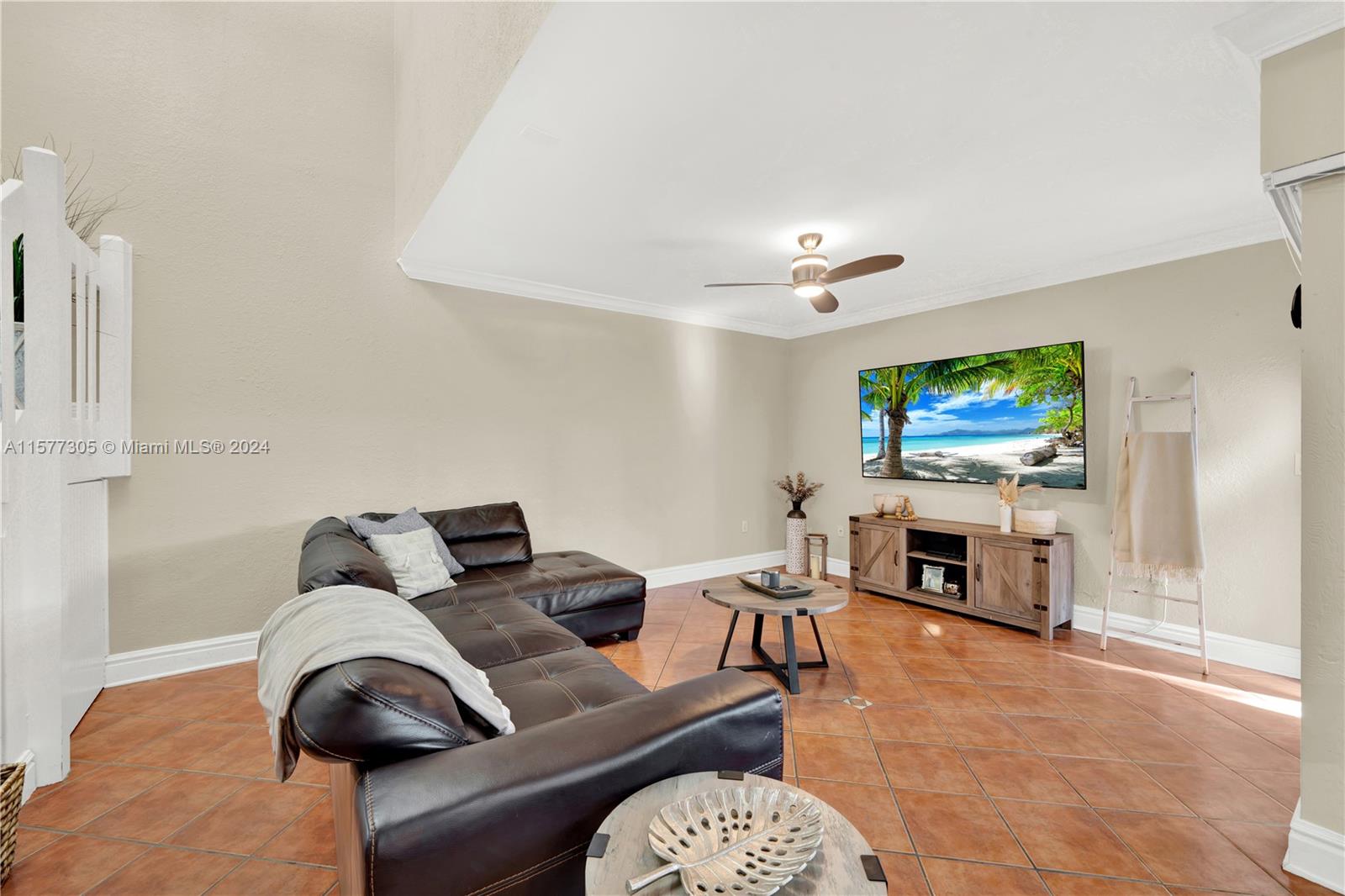 13339 Southwest 112th Terrace, Unit 504 Miami, FL 33186 - Photo 3 of 26 a living room with furniture and a flat screen tv