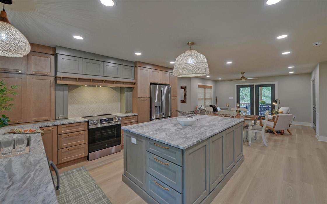 398 Hidden Point Road Hartwell, GA 30643 - Photo 3 of 46 This spacious kitchen features an island, ample counter space, and opens to a vibrant outdoor deck.
