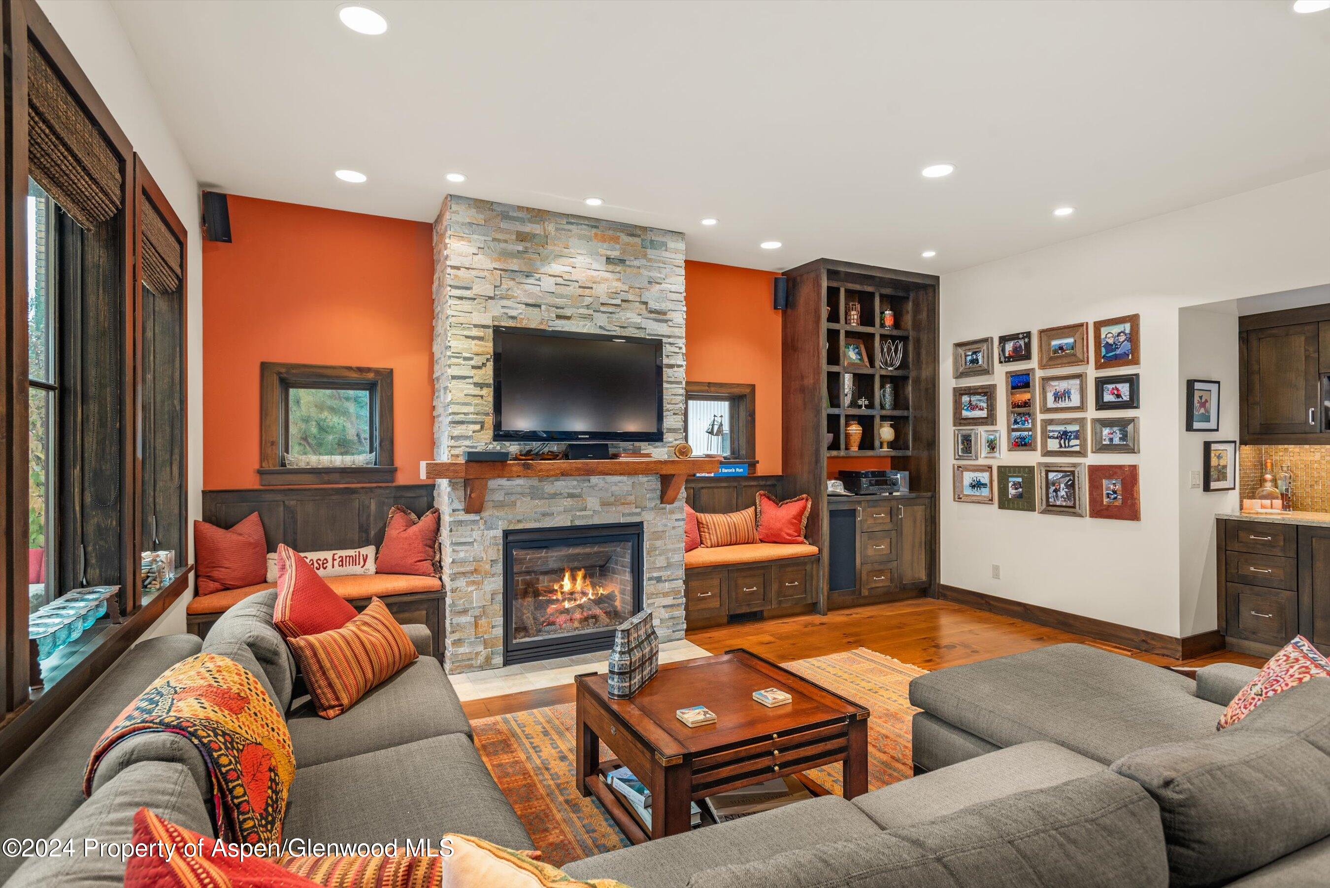 342 Sopris Circle Basalt, CO 81621 - Photo 22 of 34 a living room with furniture a flat screen tv and a fireplace