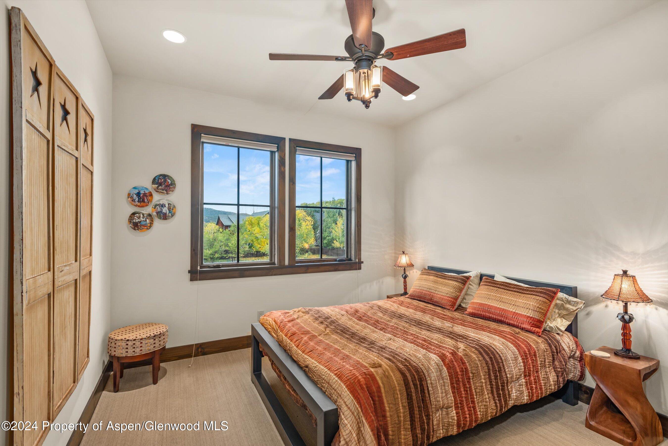 342 Sopris Circle Basalt, CO 81621 - Photo 26 of 34 a bedroom with a bed and a chandelier
