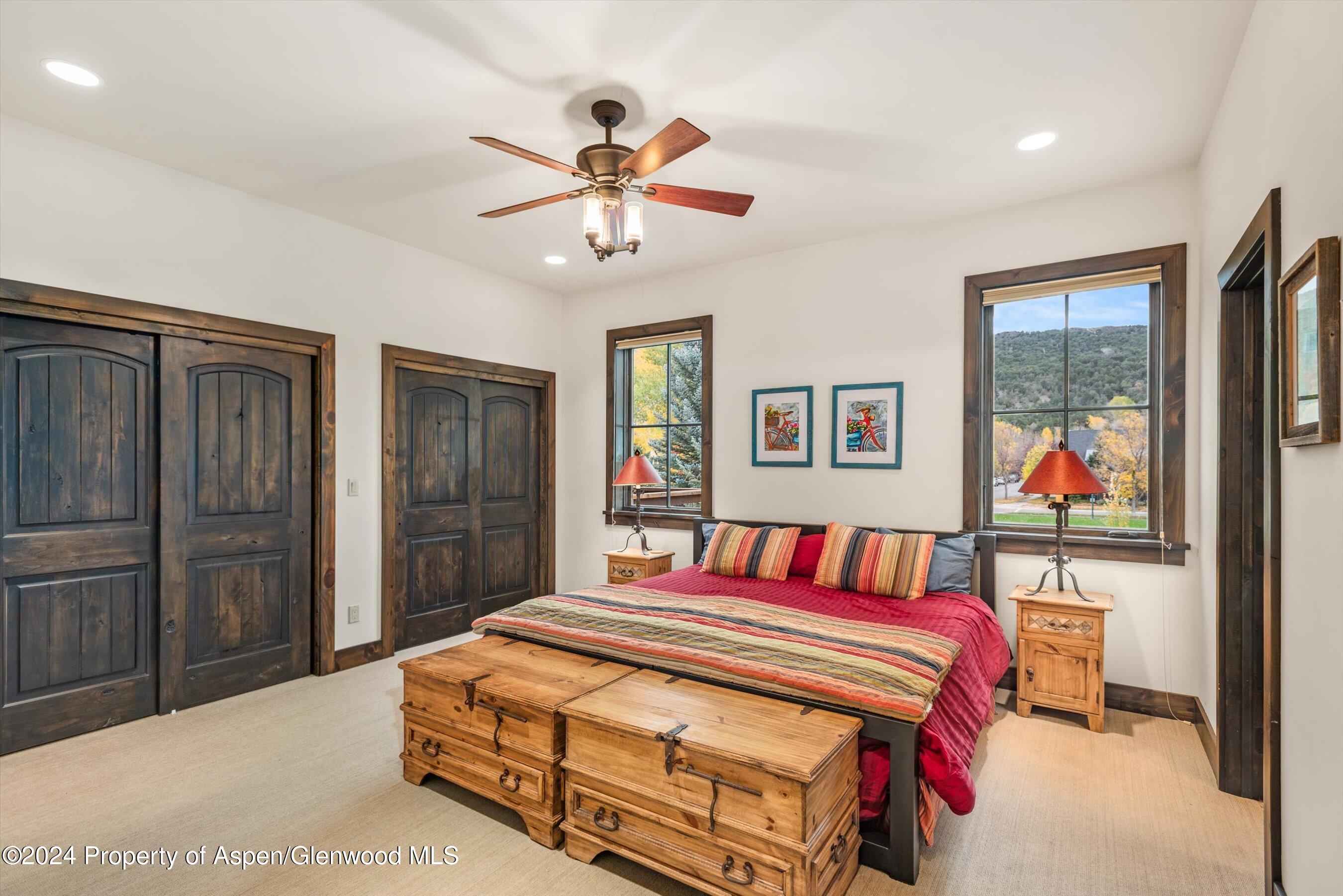 342 Sopris Circle Basalt, CO 81621 - Photo 28 of 34 a bedroom with a bed and a chandelier
