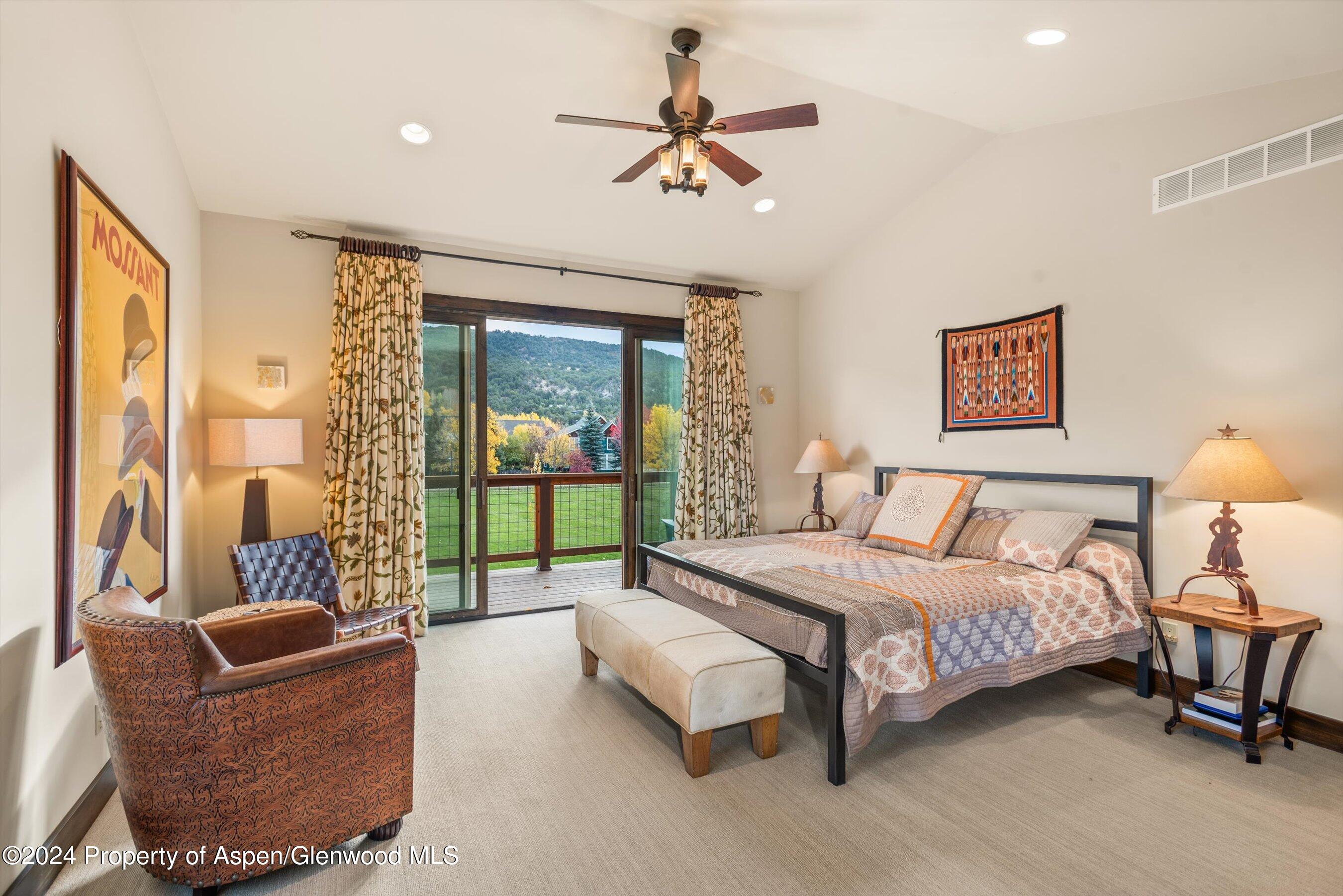 342 Sopris Circle Basalt, CO 81621 - Photo 6 of 34 a bedroom with a bed a couch and a chandelier