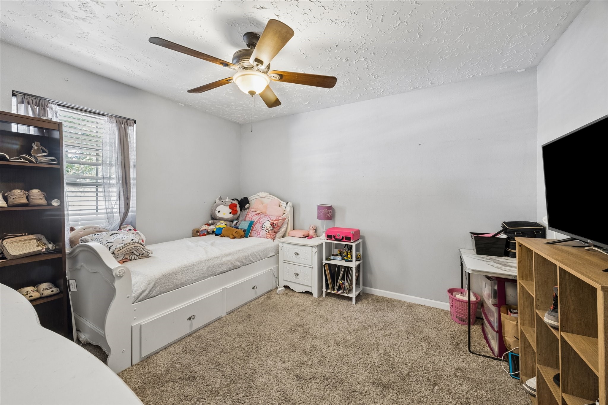 23115 Stepinwolf Lane Spring, TX 77373 - Photo 12 of 18 Cozy bedroom, perfect for a child's room with plenty of storage space.