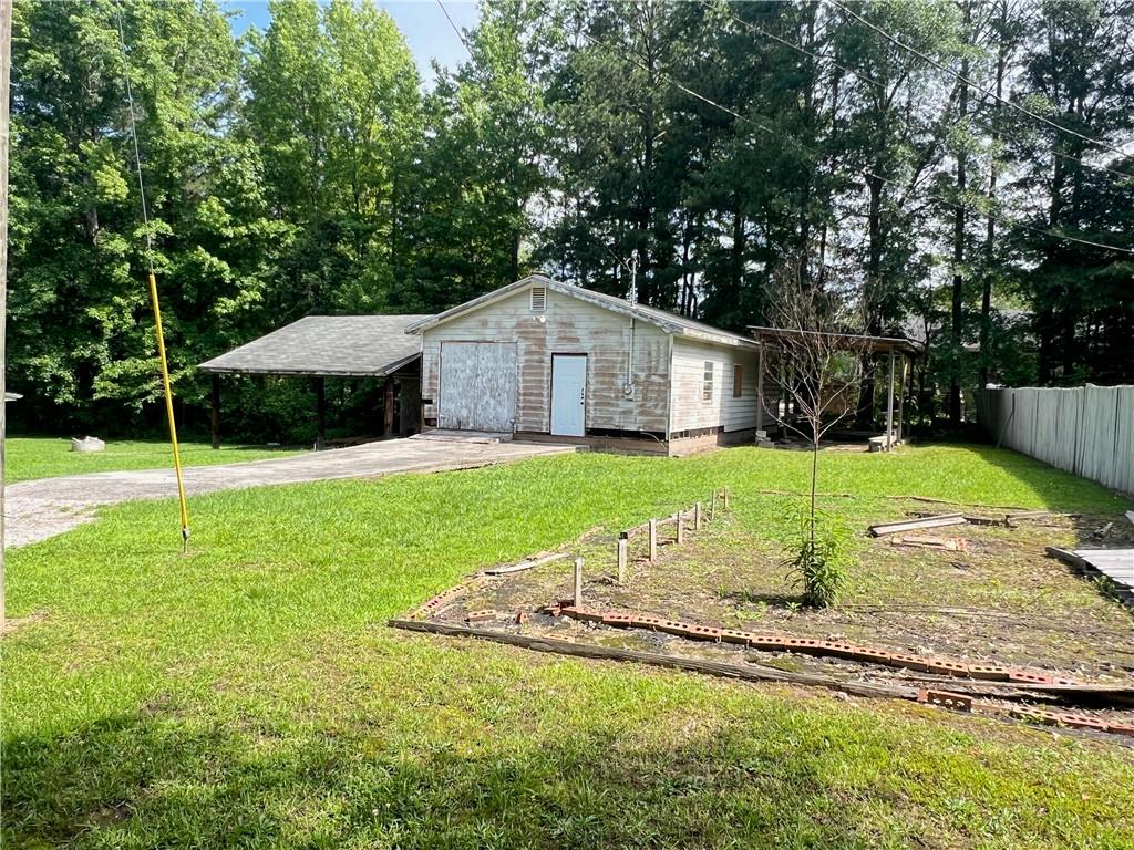 340 Womack Avenue Dallas, GA 30157 - Photo 8 of 29 a swimming pool with a garden