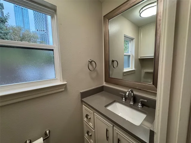 a bathroom with a sink vanity and mirror