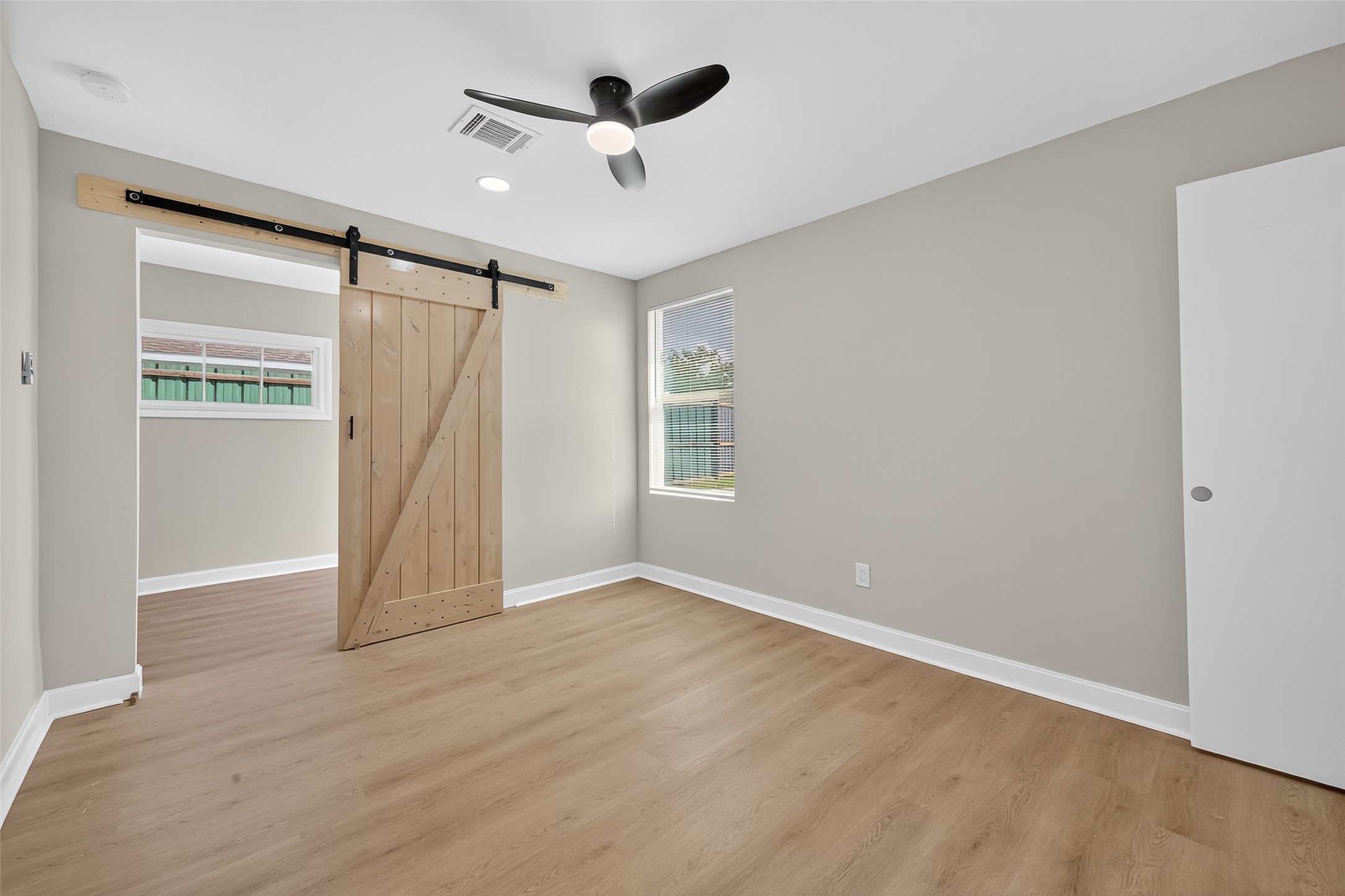 889 Chas Lane Houston, TX 77091 - Photo 24 of 32 wooden floor in an empty room with a window