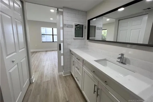 a spacious bathroom with a double vanity sink and a mirror