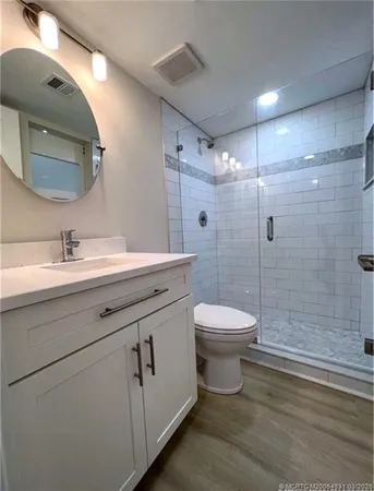a bathroom with a sink toilet and shower
