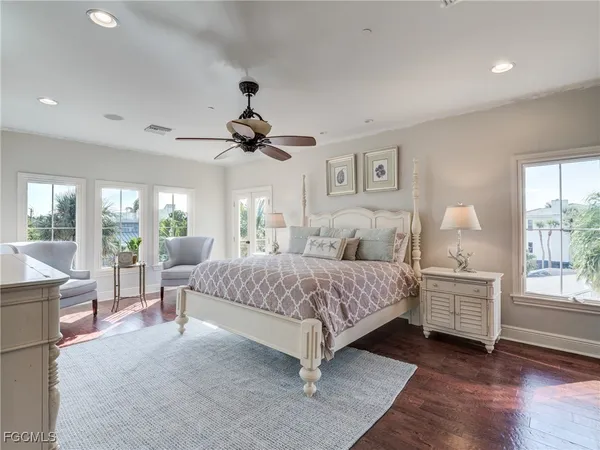 a spacious bedroom with a large bed and a chandelier