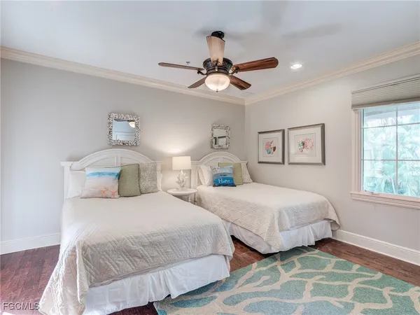 a bedroom with two beds and a chandelier