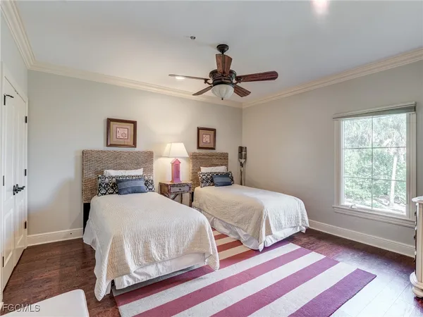 a bedroom with two beds and a window