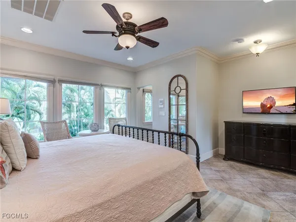 a large bed sitting in a bedroom next to a window