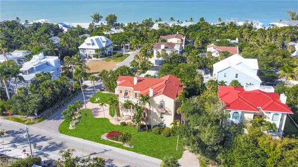 an aerial view of a house with a swimming pool yard and outdoor seating