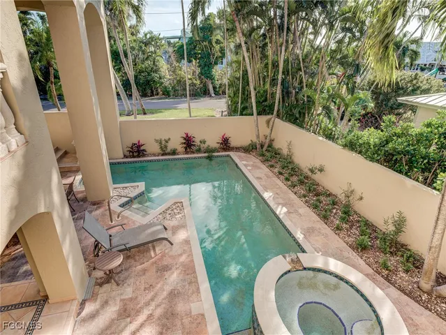 a view of a swimming pool with a patio and backyard
