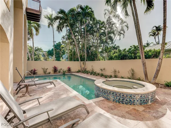 a view of a swimming pool with a patio and a garden