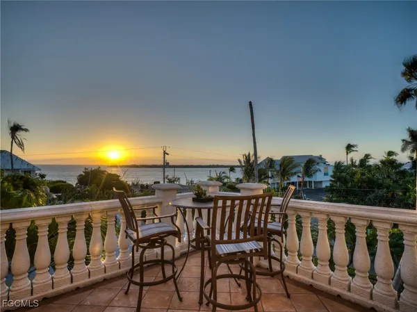 a view of a chairs and table in the balcony