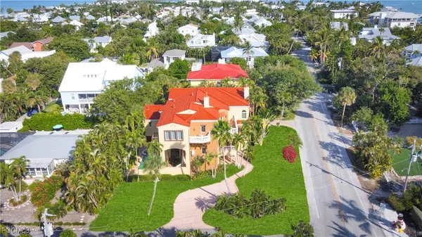 an aerial view of residential houses with outdoor space and street view