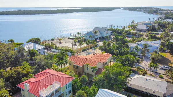 an aerial view of a house with a lake view