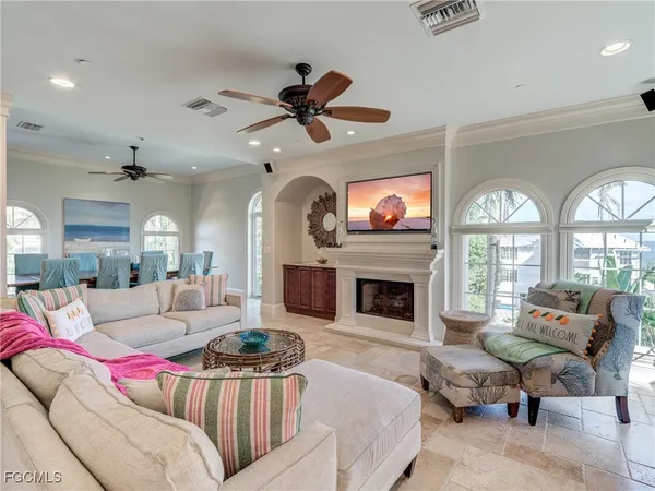 a living room with furniture fireplace and a large window