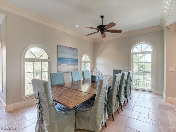 a dining room with furniture a chandelier and wooden floor