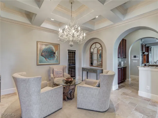 a living room with fireplace furniture and a chandelier