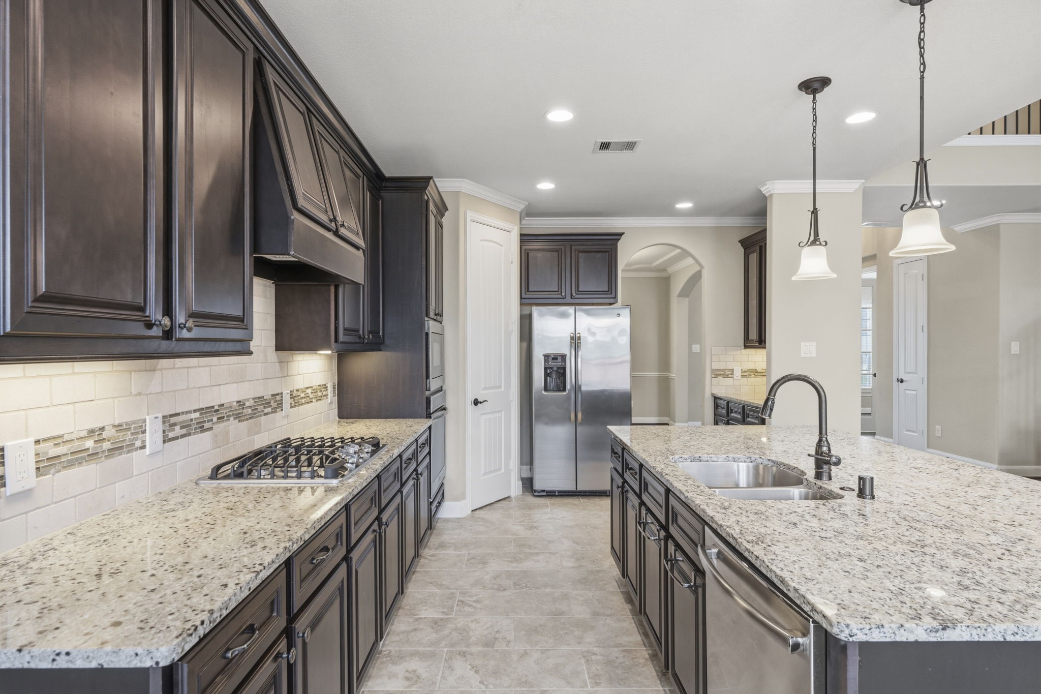 25210 Gaddis Oaks Drive Spring, TX 77389 - Photo 10 of 50 a kitchen with granite countertop stainless steel appliances a sink a counter top space cabinets and stainless steel appliances