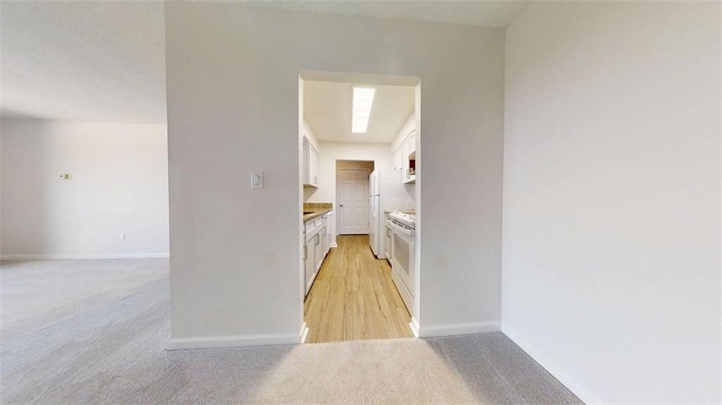 300 Johnson Ferry Road, Unit B805 Sandy Springs, GA 30328 - Photo 12 of 31 a view of a room with wooden floor and a bathroom
